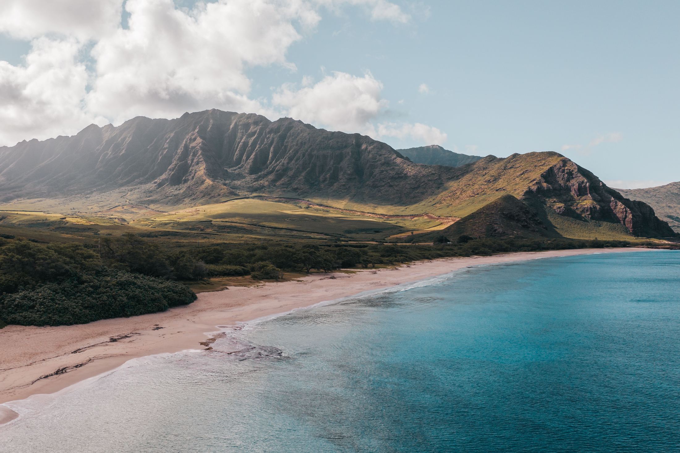 Mountains rising behind a quiet beach on Oahu's Waiʻanae coast