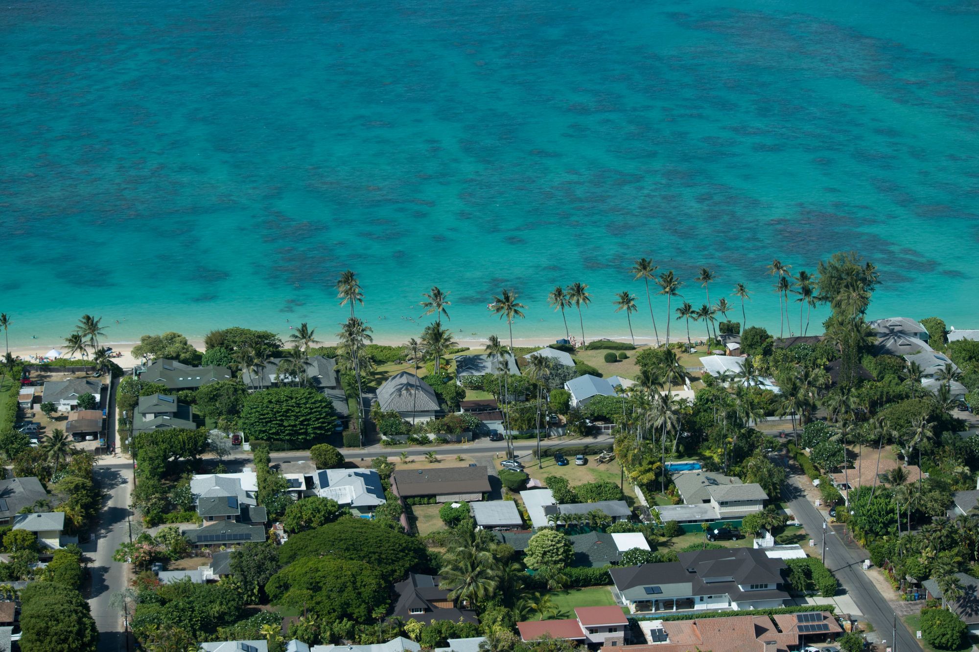 Turquoise reef water off a beach on Oahu, seen from the air