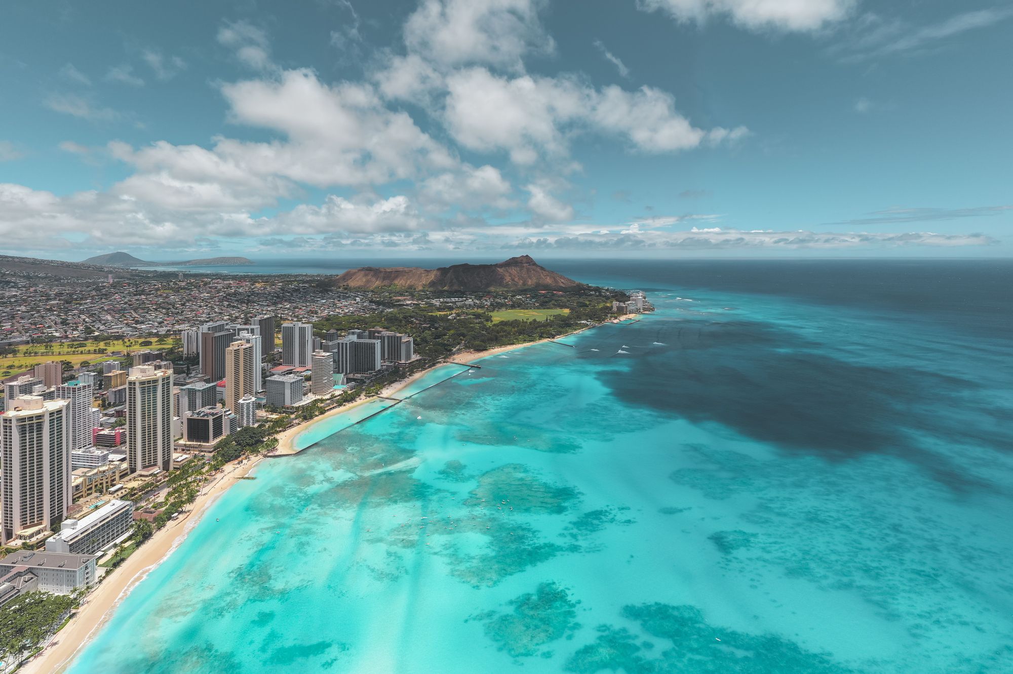 Aerial view of Waikiki Beach and the high-rise hotels with Diamond Head beyond