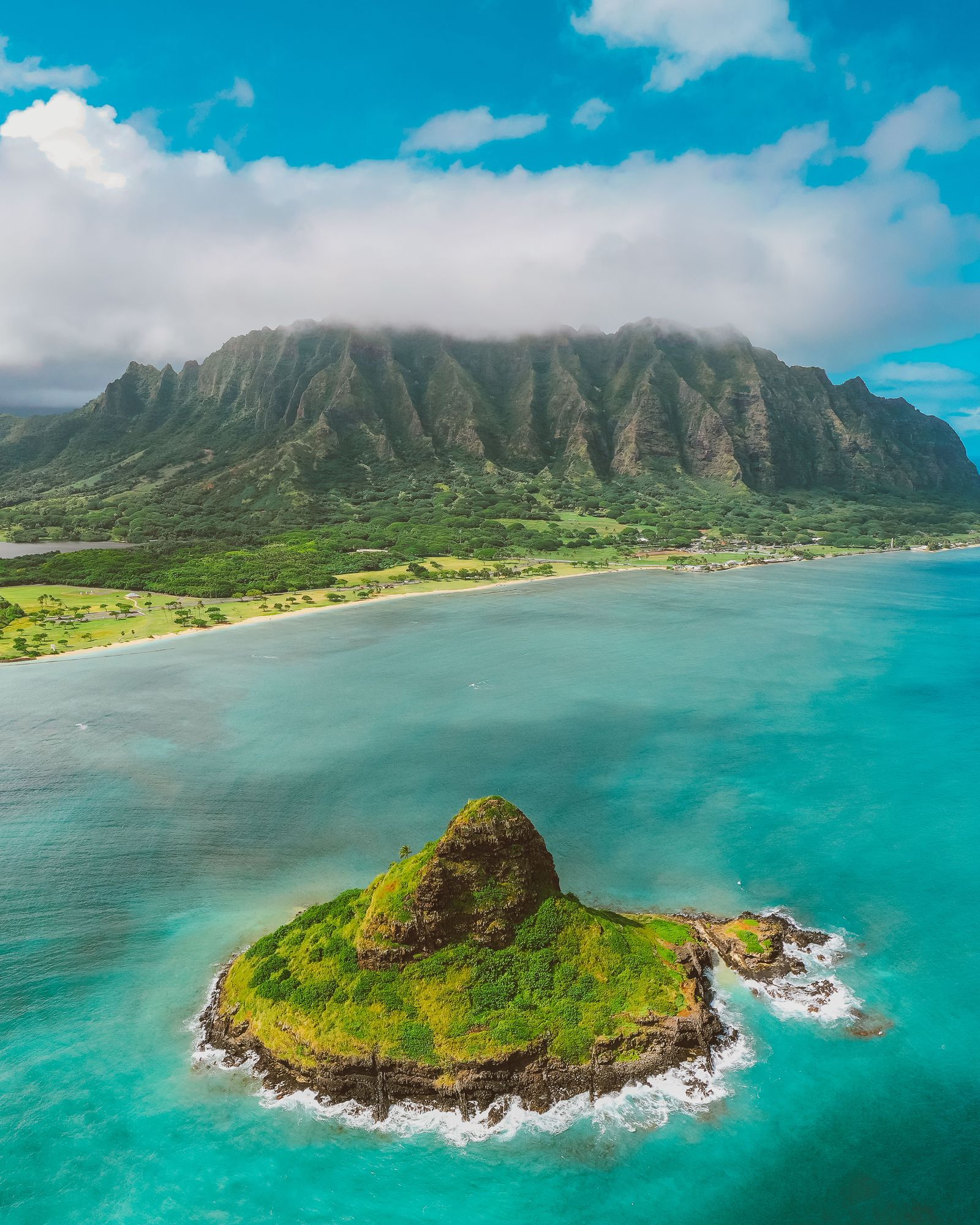 Mokoliʻi island off Kualoa, below the fluted green cliffs of the Koolau range