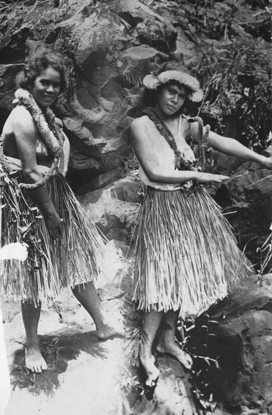 Two hula dancers in lei and grass skirts, vintage photograph